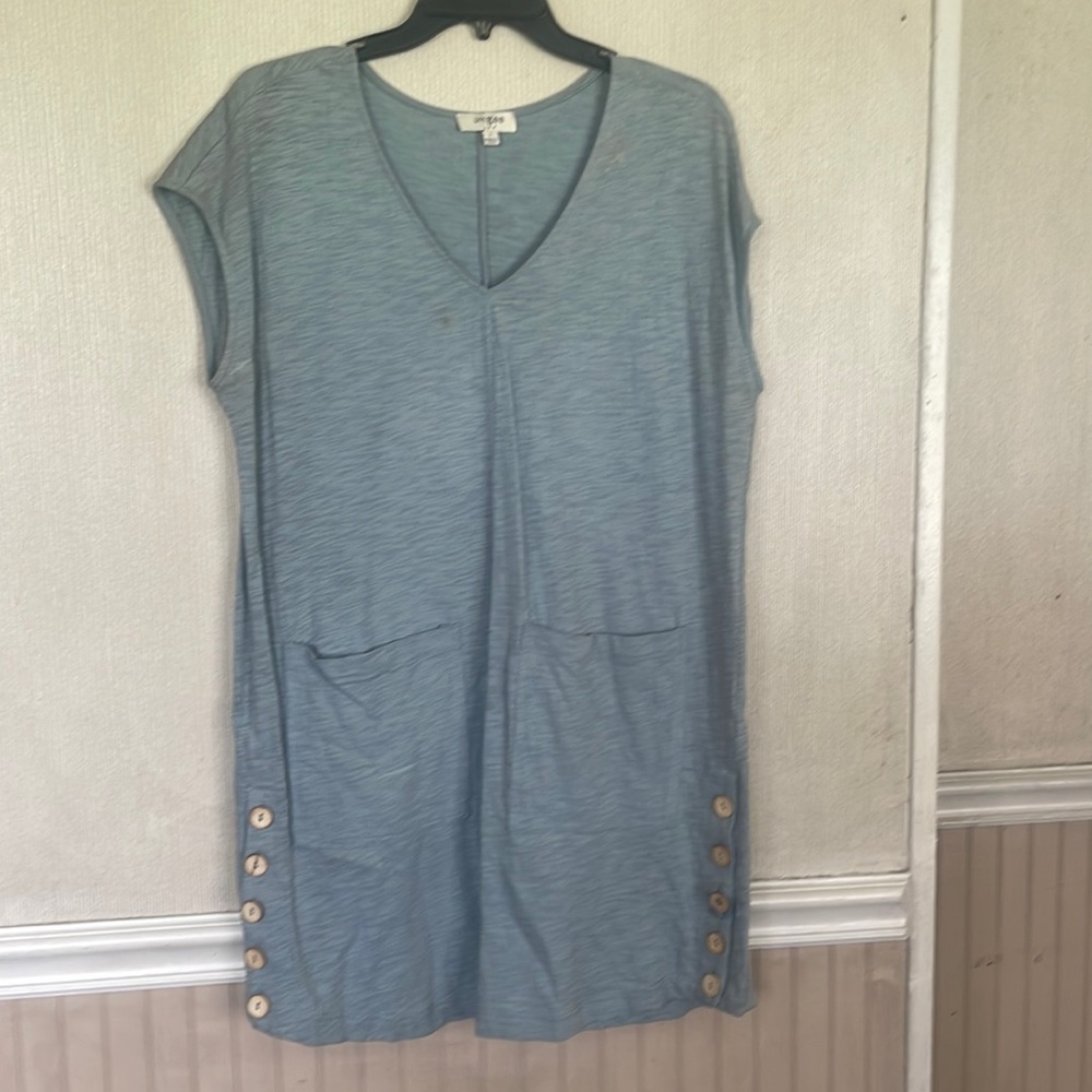 Dress with buttons on sides. A small stain on front. May come out.